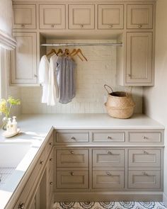 an organized kitchen with white cabinets and drawers