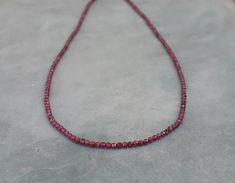 Genuine garnet gold chocker necklace,january birthstone necklace Made of 14k solid yellow gold clasp with 2mm red garnet faceted beads. This dainty and minimalist necklace is great alone or stacked with other necklaces Please select your prefered clasp: fish lock or spring *Matching bracelet in my shop! Measures: Garnet beads- 2mm Length- please select in the drop down menu