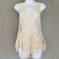 Size M/L. Sheer Off White/Cream Pol Tank Top. Cute Lace/Crocheted Detail. Never Worn. Pit To Pit: Approximately 19 Inches Pit To Bottom: Approximately 27 Inches Summer Beige Tops With Delicate Lace, Summer Beige Delicate Lace Top, Beige Delicate Lace Summer Tops, Summer Cream Crochet Top With Lace Patchwork, Beige Sleeveless Lace Crochet Top, Cream Crochet Top With Lace Patchwork For Summer, Cream Crochet Top With Lace Trim, Beige Crochet Top With Lace Trim For Festival, Beige Crochet Lace Top With Lace Trim