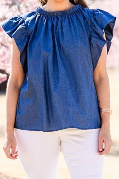 We are so in love with this top! It offers a lovely aesthetic with its flutter sleeves, high neckline, and versatile pairing options! The chic back tie is super cute! Elevate your style with this chic piece, perfect for completing a classy and sophisticated look! 100% Cotton Chic Blouse With Ruffle Sleeves, Chic Fitted Denim Top With Ruffles, Spring Short Sleeve Denim Top With Ruffles, Spring Denim Top With Ruffles Short Sleeve, Spring Denim Top With Ruffles And Short Sleeves, Chic Short Sleeve Denim Top For Day Out, Chic Flutter Sleeve Blouse For Spring, Spring Fitted Blouse With Flutter Sleeves, Chic Spring Blouse With Flutter Sleeves