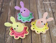 three crocheted toy animals sitting on top of a wooden floor next to each other