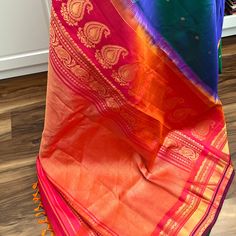 This beautiful Gadwal Silk Saree is a classic handwoven piece crafted using the finest silk. Show off your style in this elegant saree, featuring two tone peacock blue with buttis on the body while the kuttu borders and the grand pallu in two tone pink. The matching blouse piece is in two tone pink. Perfect for any special occasion, you'll love the quality and finish of this gadwal saree. Approximate Length 6.5 mtrs (inclusive of blouse length) Approximate Height - 48 - 52" Approximate weight - 1.7 lbs Saree comes with fall, picot and tassels done when applicable. Blouse piece is cut. Kindly Note : The colors you see on your device may vary due to the color reproduction, brightness and resolution of individual devices. If you'd like more clarity before your purchase, please contact our sup Festive Multicolor Katan Silk Pre-draped Saree, Luxury Multicolor Katan Silk Pre-draped Saree, Purple Pre-draped Saree With Pallu In Katan Silk, Yellow Katan Silk Pre-draped Saree, Gold Tussar Silk Pre-draped Saree With Pallu, Silk Cotton Sarees, Elegant Saree, Peacock Blue, Blouse Length