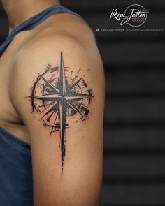 a man with a compass tattoo on his arm