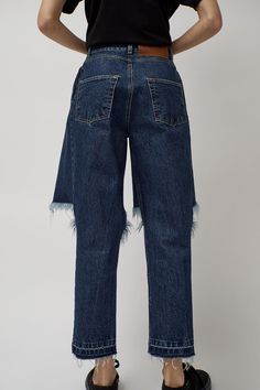 High waist jean with split knee and pieced front panels that mimic cut-off shorts. Four pocket construction, zip fly closure, and belt loops. Ripped Denim Blue Cropped Jeans In Rigid Denim, Ripped Cropped Jeans In Denim Blue, Ripped Denim Blue Cropped Jeans, Flare Jeans In Denim Blue With Belt Loops, Blue Cutoff Rigid Denim Jeans, Cutoff Jeans For Streetwear, Blue Flare Jeans With Belt Loops In Recycled Denim, Edgy Cutoff Bottoms With Belt Loops, Cutoff Jeans With Frayed Hem In Recycled Denim