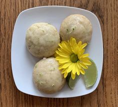 some food on a white plate with a yellow flower