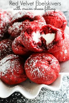 red velvet cookies with cream cheese filling in a white bowl on a black and white table