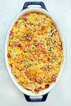 a casserole dish with meat and cheese in it on a white table top