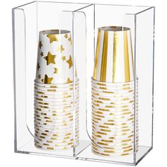 two gold and white vases are in a clear case with golden stars on them