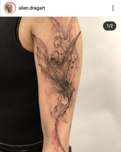 a woman's arm with a tattoo on it that has an image of a dragon and flowers