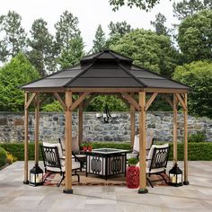 a gazebo sitting on top of a stone patio