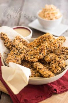 chicken fingers in a bowl with dipping sauce