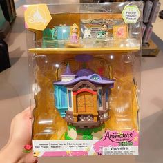 someone is holding up a toy house in the box that they are selling for $ 3