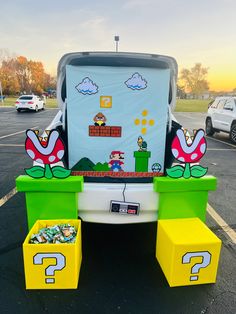 the back end of a car with mario bros decorations on it's hood and bench