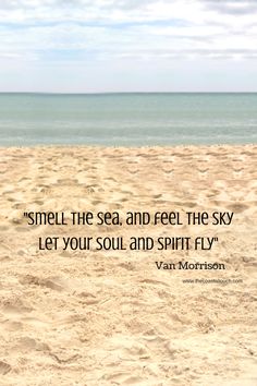 a person sitting on top of a sandy beach next to the ocean with a quote above it