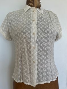 Fun white sheer blouse; five pearl shaped buttons, adorned with a sparkle centre. Short sleeves  Armpit to armpit 17" Sleeve to sleeve 24" Neck to hem 20" Good vintage condition; age related discolouration SHOP THE STORE:  https://www.etsy.com/shop/BrocanteBedStuy Sheer Fitted Button-up Shirt, Fitted Sheer Button-up Shirt, Sheer Fitted Button-up Blouse, Fitted Sheer Button-up Blouse, Classic Sheer Button-up Tops, Classic Sheer Tops For Formal Occasions, Classic Sheer Top For Formal Occasions, Fitted Collared Tops With Pearl Buttons, White Sheer Button-up Blouse