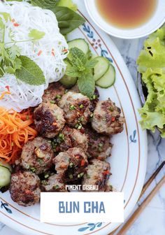 a white plate topped with meatballs and veggies next to a cup of tea