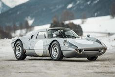 an old race car is parked in the snow