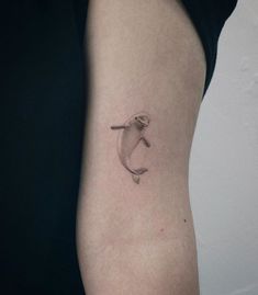 a small dolphin tattoo on the right thigh