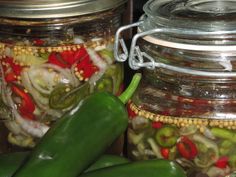 two glass jars filled with pickles and onions