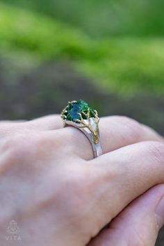 Forest Diopside Ring features a raw gemstone crystal set in sterling silver, evoking the essence of a magical drop from an enchanted forest lake. Adorned with gold-plated branches and a stone-like texture, this ring captures the mystical beauty of nature's hidden treasures. The author's hand-made model,  sterling silver 925,  natural raw diopside ❗️Irregularities and chips may be present on the gemstones. Raw gems can have various inclusions and other natural effects. These are natural crystals, and this is their specialty and charm. Shipping and taxes: Please note the shipping and delivery times below. If the jewelry is in stock, I ship it in 1-2 business days. If the jewelry is made to order, I will ship it in 2-5 weeks.  ✨There will be no taxes and fees at customs. Packing: Jewelry pack Handmade Green Mystical Jewelry, Green Spiritual Jewelry With Natural Inclusions, Adjustable Nature-inspired Crystal Ring For Gifts, Green Electroformed Bohemian Jewelry, Luxury Nature-inspired Electroformed Jewelry, Boho Statement Ring, Wiccan Jewelry, Packing Jewelry, Pagan Jewelry