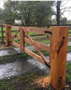 a wooden fence in the middle of a field