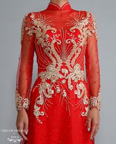 Custom made red Ao Dai with gold lace Materials: lace, sparkling pearl tulle, crystals Neckline: tall collar with beaded embellishment Long sleeves Closure: Zipper Chiffon pants Sweep train Red Embellished Long Sleeve Gown, Red Wedding Dress With Sheer Bodice, Red Long Sleeve Reception Dress, Red Wedding Gown With Sheer Bodice, Elegant Red Gown With Intricate Embroidery, Elegant Red Dress With Gold Embroidery, Red Long Sleeve Gown With Intricate Embroidery, Long Sleeve Red Gown With Intricate Embroidery, Red Gown With Sheer Bodice For Formal Occasions