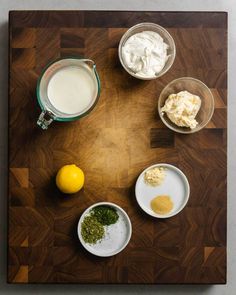 the ingredients for this dish are arranged on a cutting board, including lemons and whipped cream