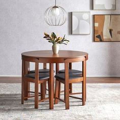 a table with two chairs and a potted plant