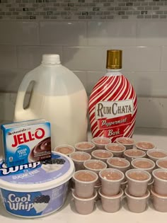 the ingredients to make an ice cream dessert are displayed on a kitchen counter, including milk, yogurt and other items