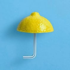 a yellow umbrella on a blue background with a white stick sticking out of it's side