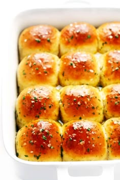 a casserole dish filled with rolls covered in cheese and seasoning