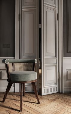 a chair sitting on top of a hard wood floor next to white walls and doors