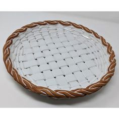 a white and brown basket sitting on top of a table