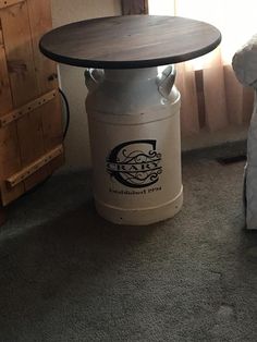 a round table sitting on top of a white bucket