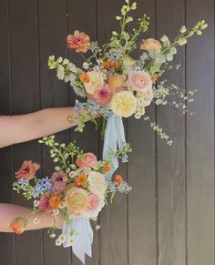 a bouquet of flowers is being held by someone's hand