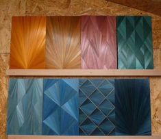 four different colors of wood are shown on the wall in front of each other, including blue and orange