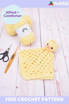 a crochet pattern for a baby blanket with scissors and yarn on the table