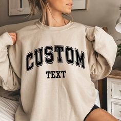 Custom Text Sweatshirt Vintage College Letters Sweatshirt Gift Retro Oversized Sweater Personalized Add Your Own Text Custom Quote Varsity Plus sizes also available: 2X, 3X, 4X, 5X -------- HOW TO ORDER -------- 1) Select your sweatshirt Size 2) Select your desired Color 3) Add personalization. 4) Click "Add to Cart" and place your order. 5) Repeat for more items. Ideal for any situation, a unisex heavy blend crewneck sweatshirt is pure comfort. These garments are made from polyester and cotton. Oversized T-shirt With Ribbed Cuffs For College, Oversized T-shirt For College, College Letter Print Drop Shoulder Tops, Oversized Collegiate Sweatshirt For College, Oversized Crew Sweats For College, Oversized Crew Neck Sweatshirt For College, Oversized Varsity College Sweats, Oversized Crew Neck Hoodie With Lettering, Oversized Varsity Sweats For College