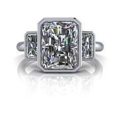 a diamond engagement ring with three princess cut diamonds on the band and sidestones in white gold