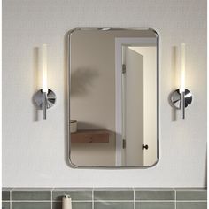 a bathroom mirror mounted to the side of a wall