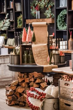 a christmas display in a store filled with lots of holiday decorations and trees on top of logs