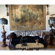 a zebra print wall hanging over a couch in front of a painting on the wall