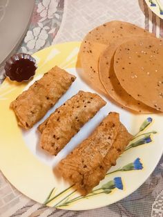 some food is sitting on a yellow and white plate next to a brown pancake