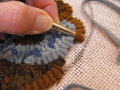 a person is working on something with yarn