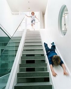 a person laying on the ground in front of some stairs