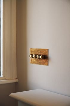 a light switch on the wall next to a window