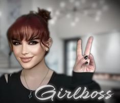 a woman making the peace sign with her hand in front of her face and text reading girlboss