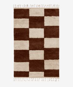 a brown and white rug with squares on it