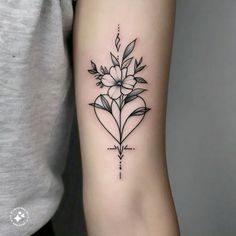 a black and white flower tattoo on the right arm, with an arrow in the middle