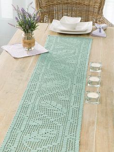 the table runner is knitted and ready to be used as a placemat or centerpiece